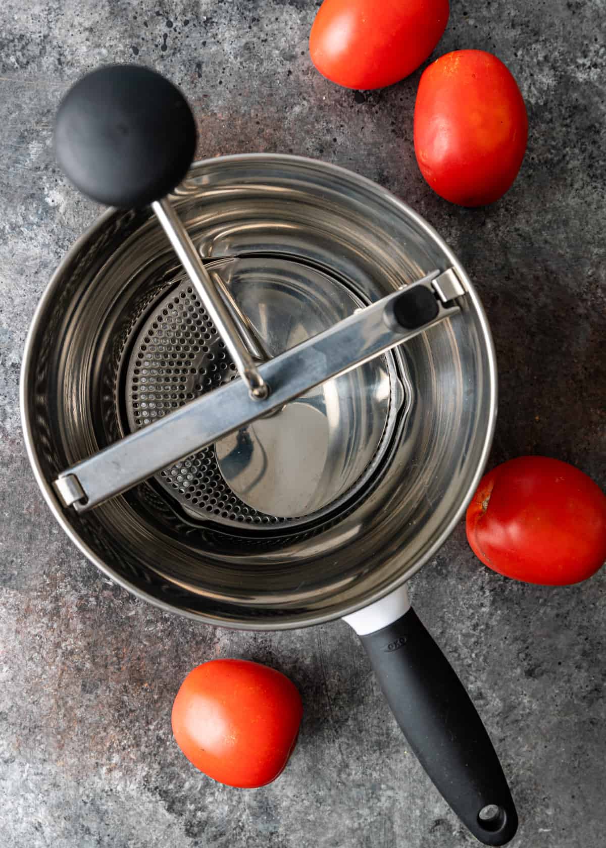 manual strainer with tomatoes
