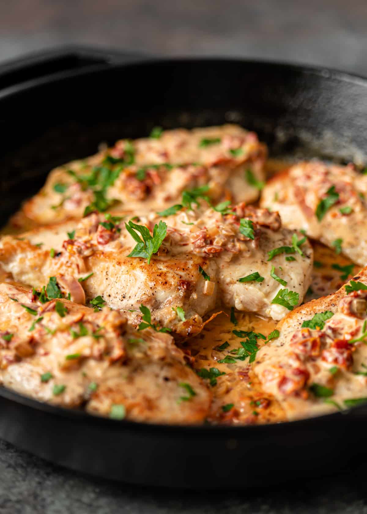 side view of a skillet with Creamy Tuscan Chicken