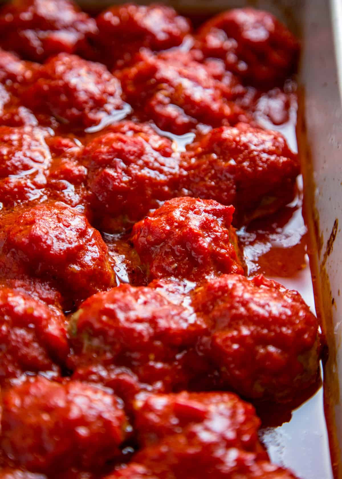 closeup: roasted Italian meatballs with marinara sauce
