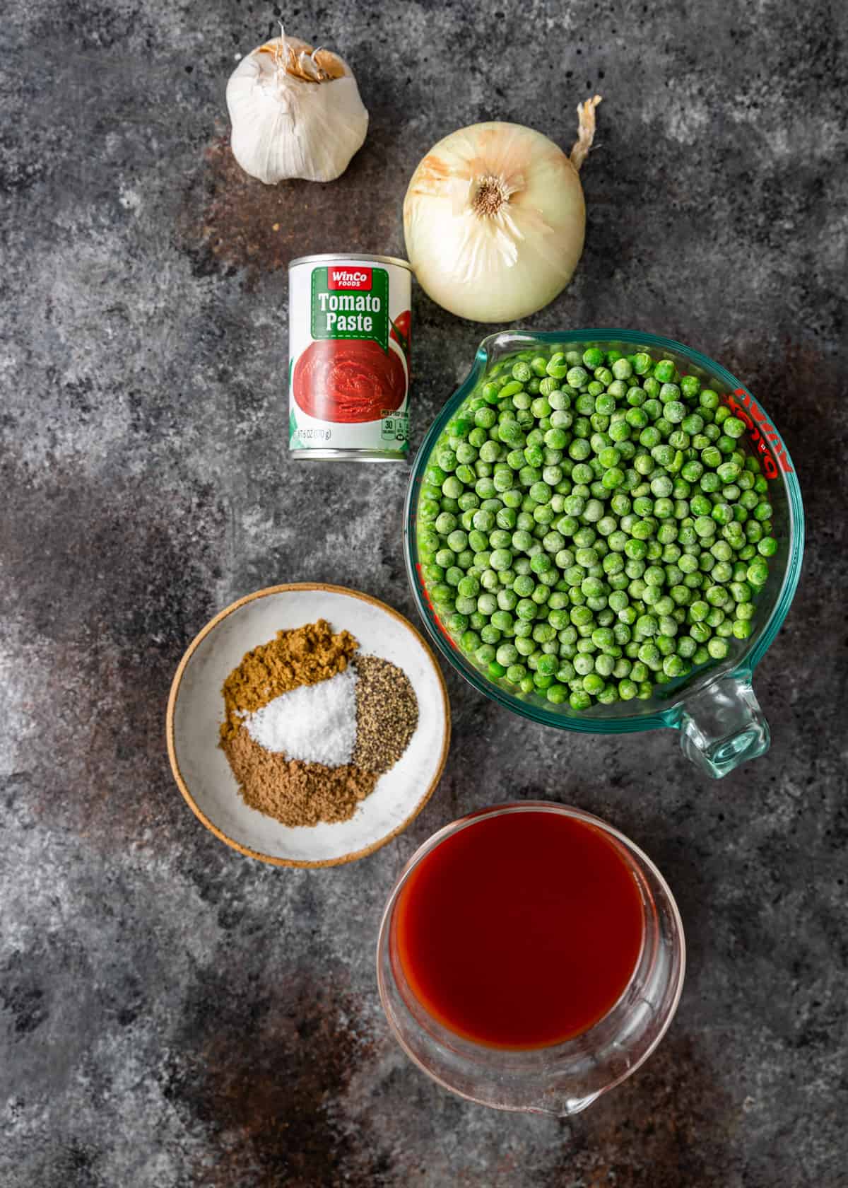 top down view of Egyptian pea stew ingredients: onion, garlic, peas, spices, tomato paste