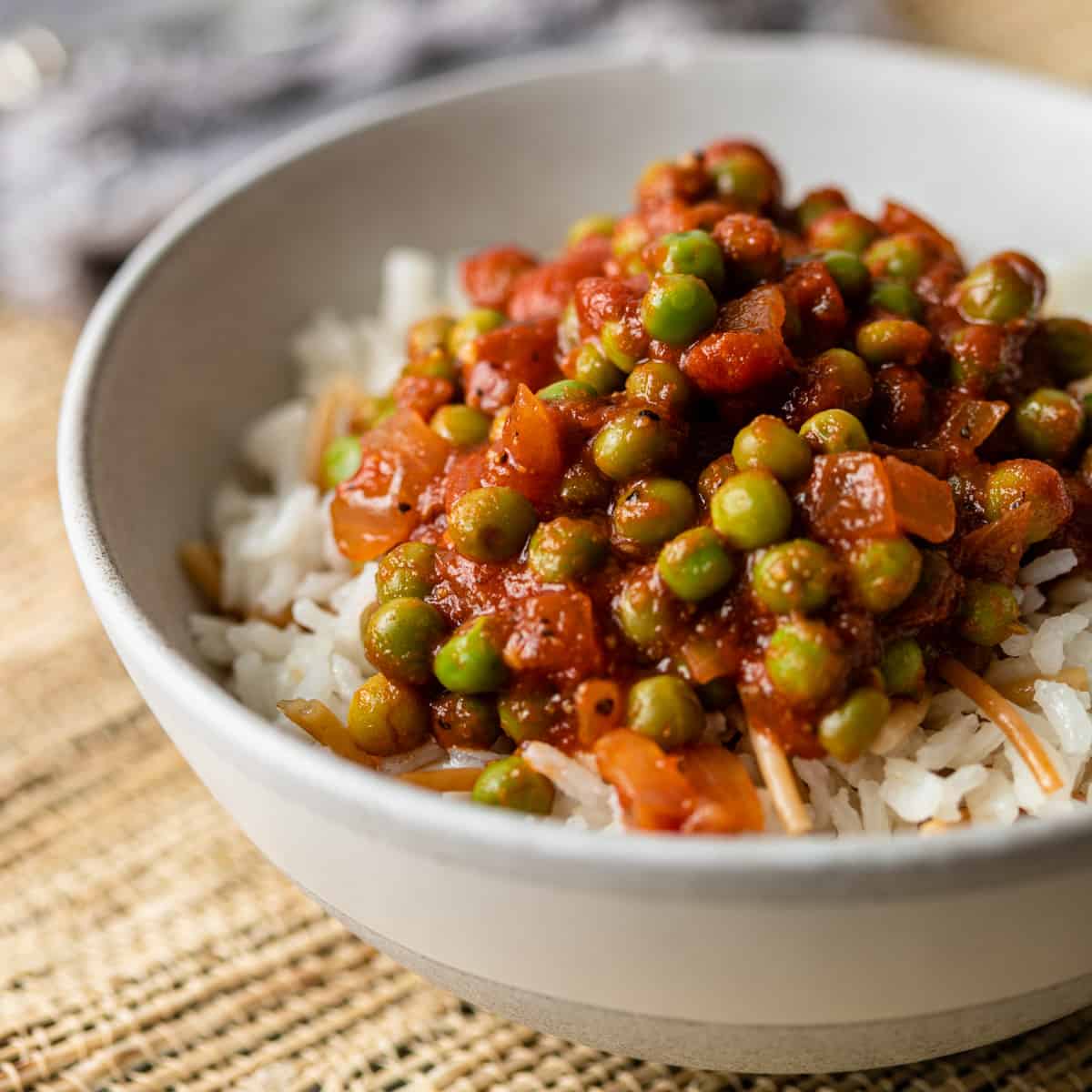 close up of Egyptian pea stew in a bowl with rice and vermicelli