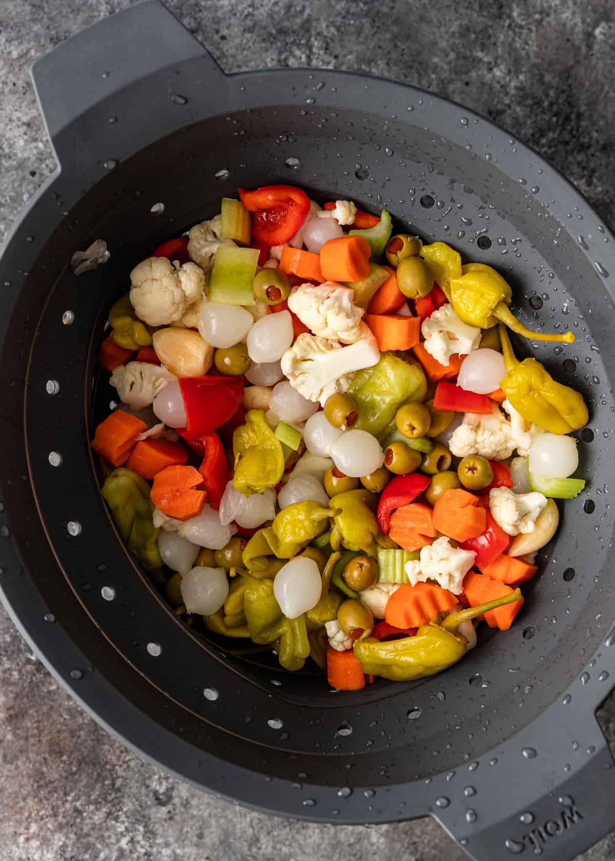 overhead: rinsed vegetables in a colander after being salted 
