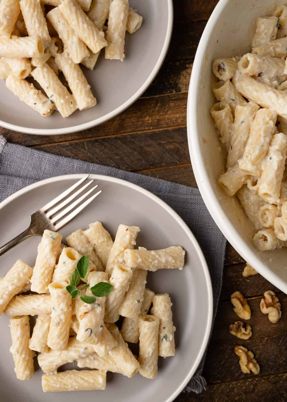 overhead: several plates of white pesto pasta