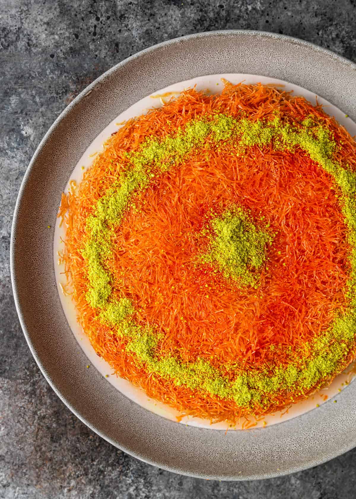 overhead: kunafa with chopped pistachios on top