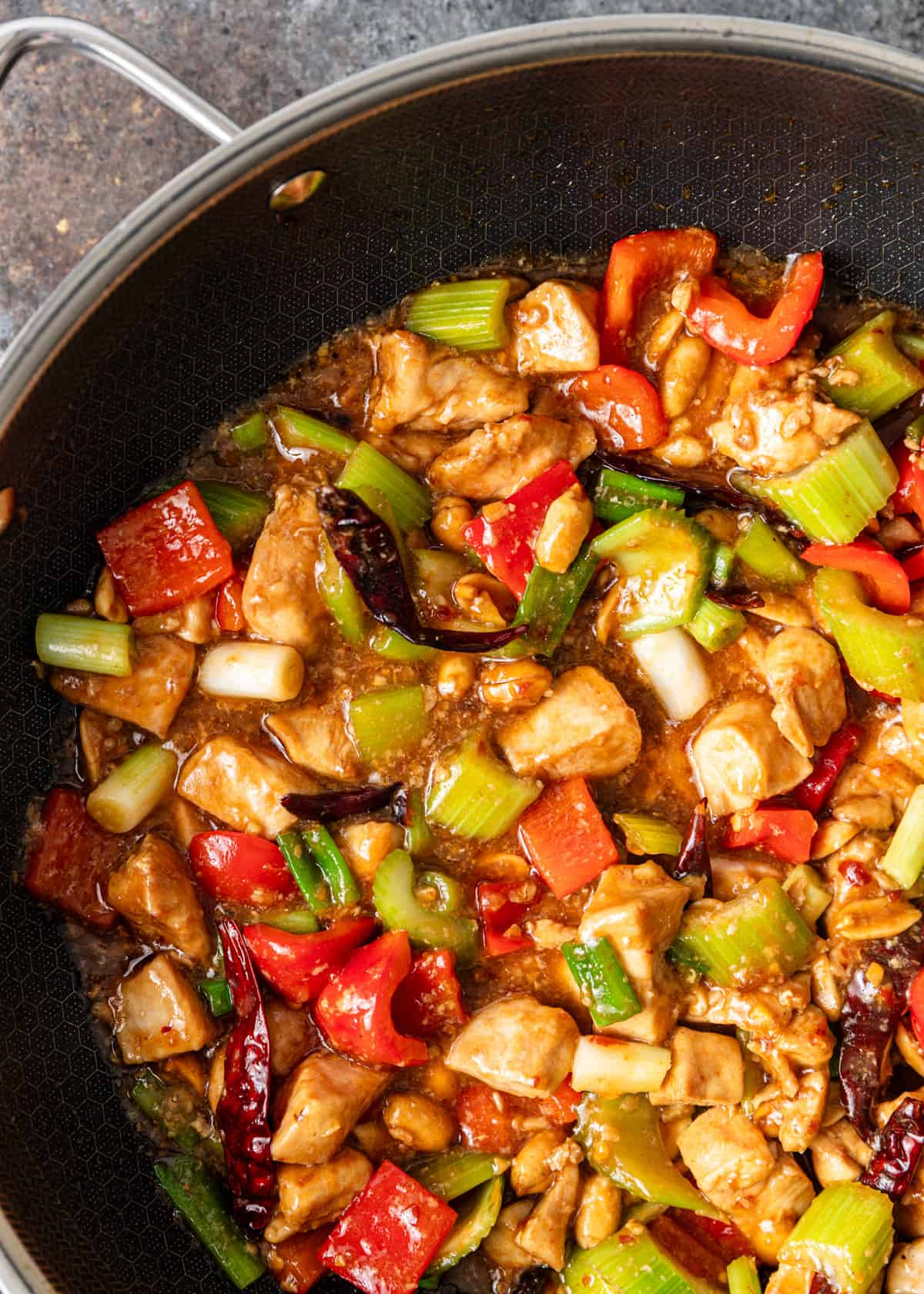 overhead closup: cooking kung pao chicken in a skillet