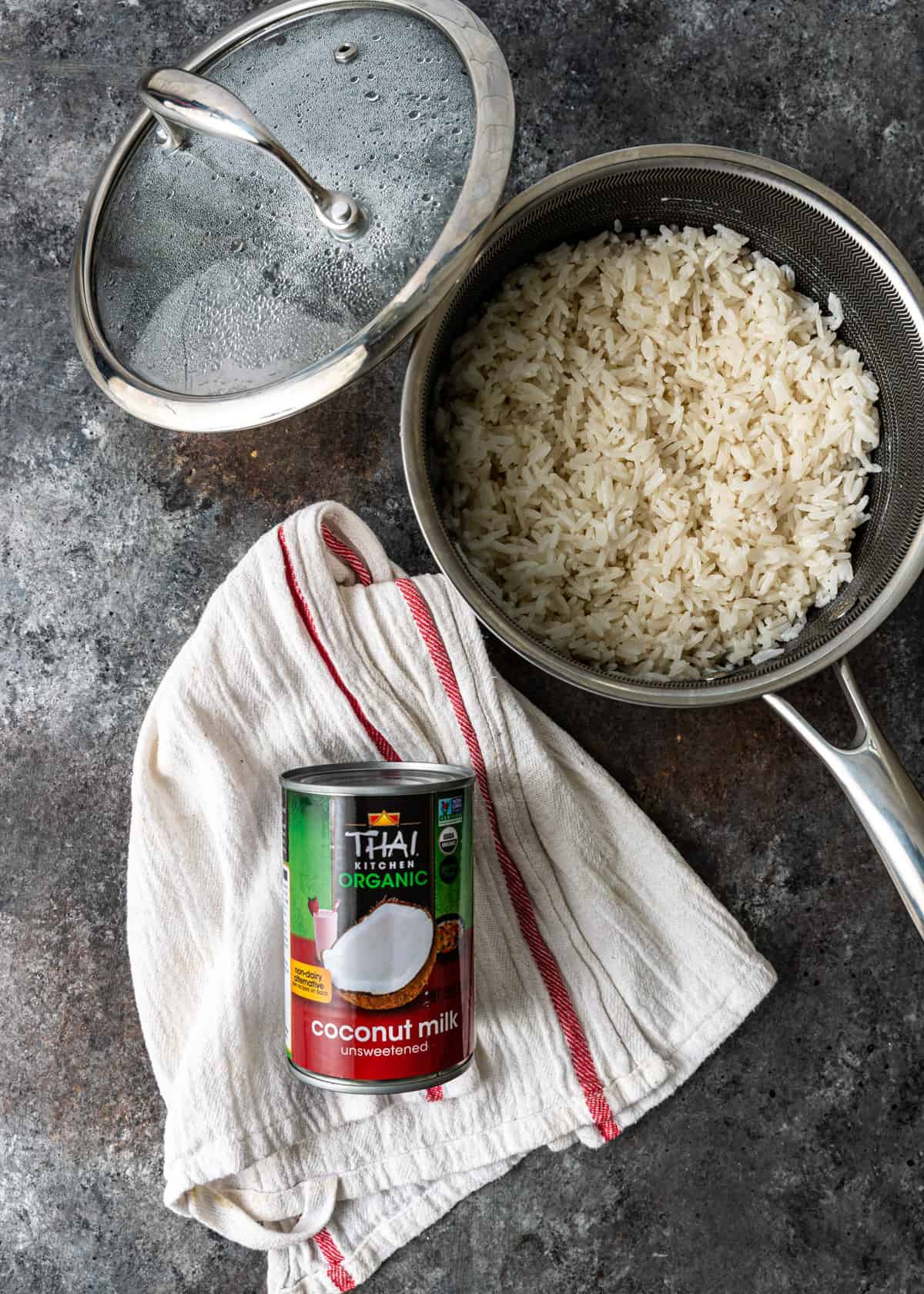 overhead: a pot of cooked rice with a can of coconut milk