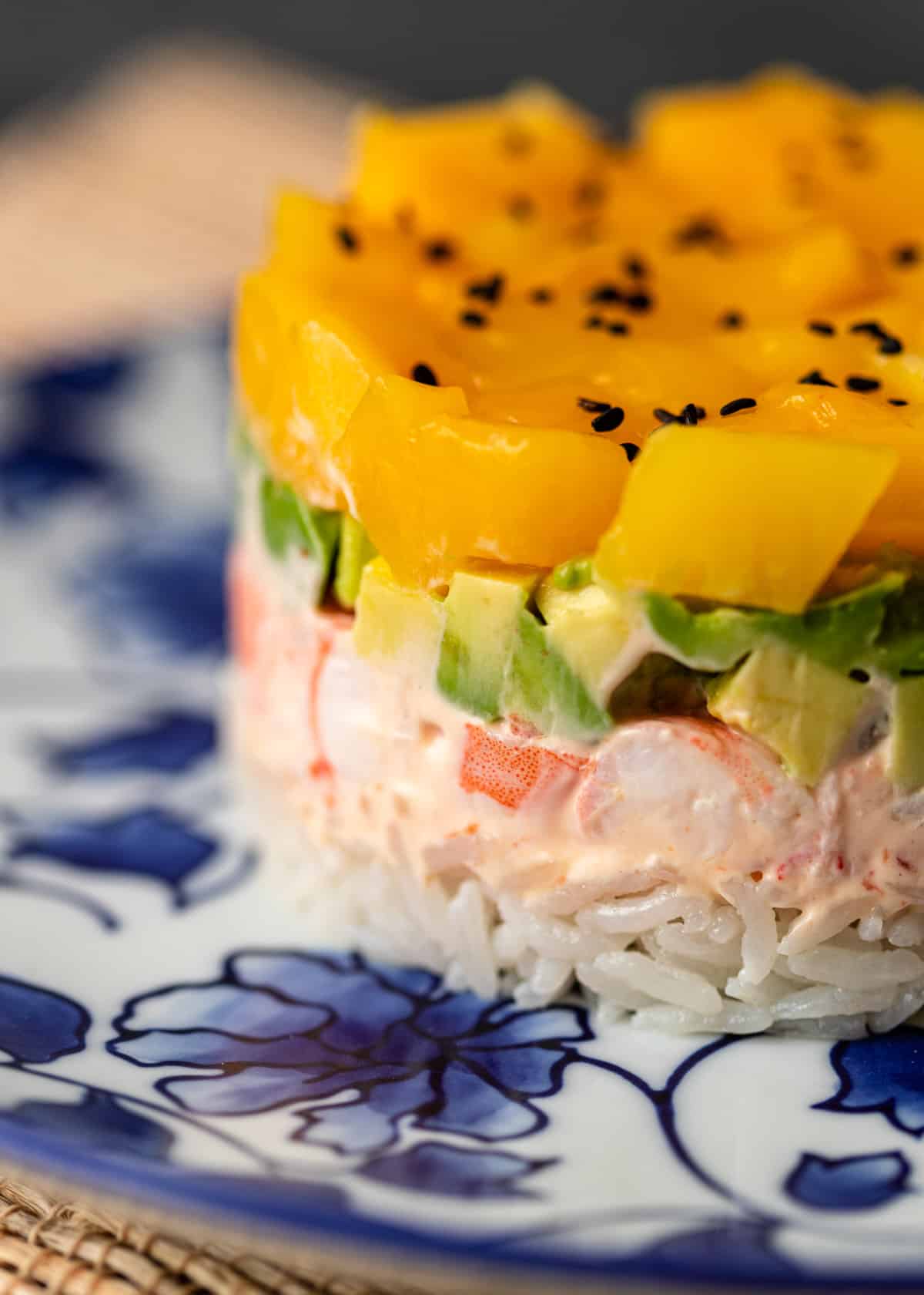extreme closeup: mango shrimp sushi stack with layers visible