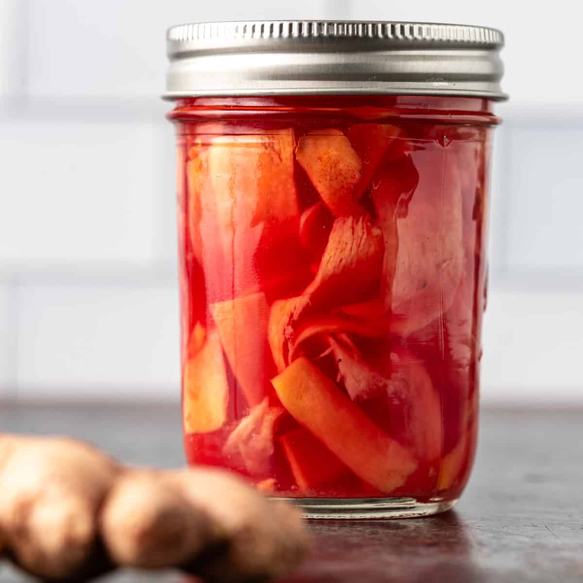 closeup: pickled ginger in a glass jar with a lid