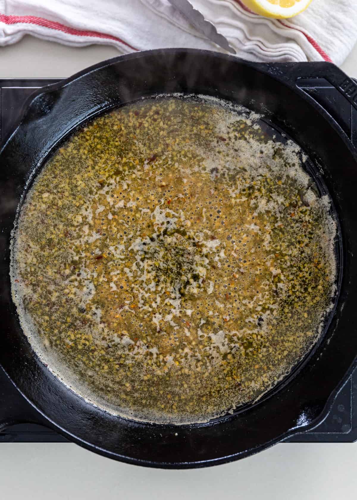 overhead: sautéing garlic in a pan