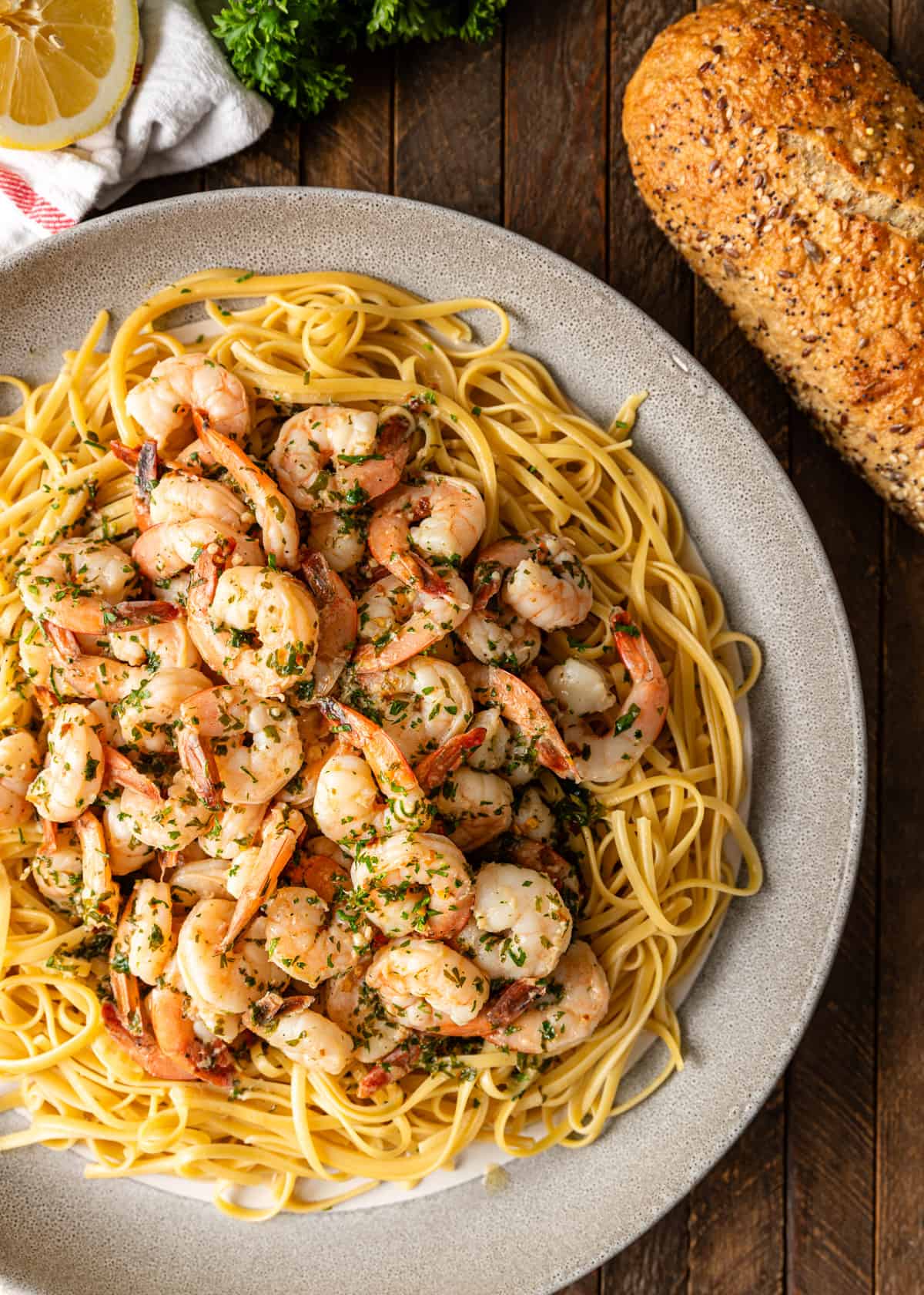 overhead: shrimp scampi recipe over linguine with bread on the side