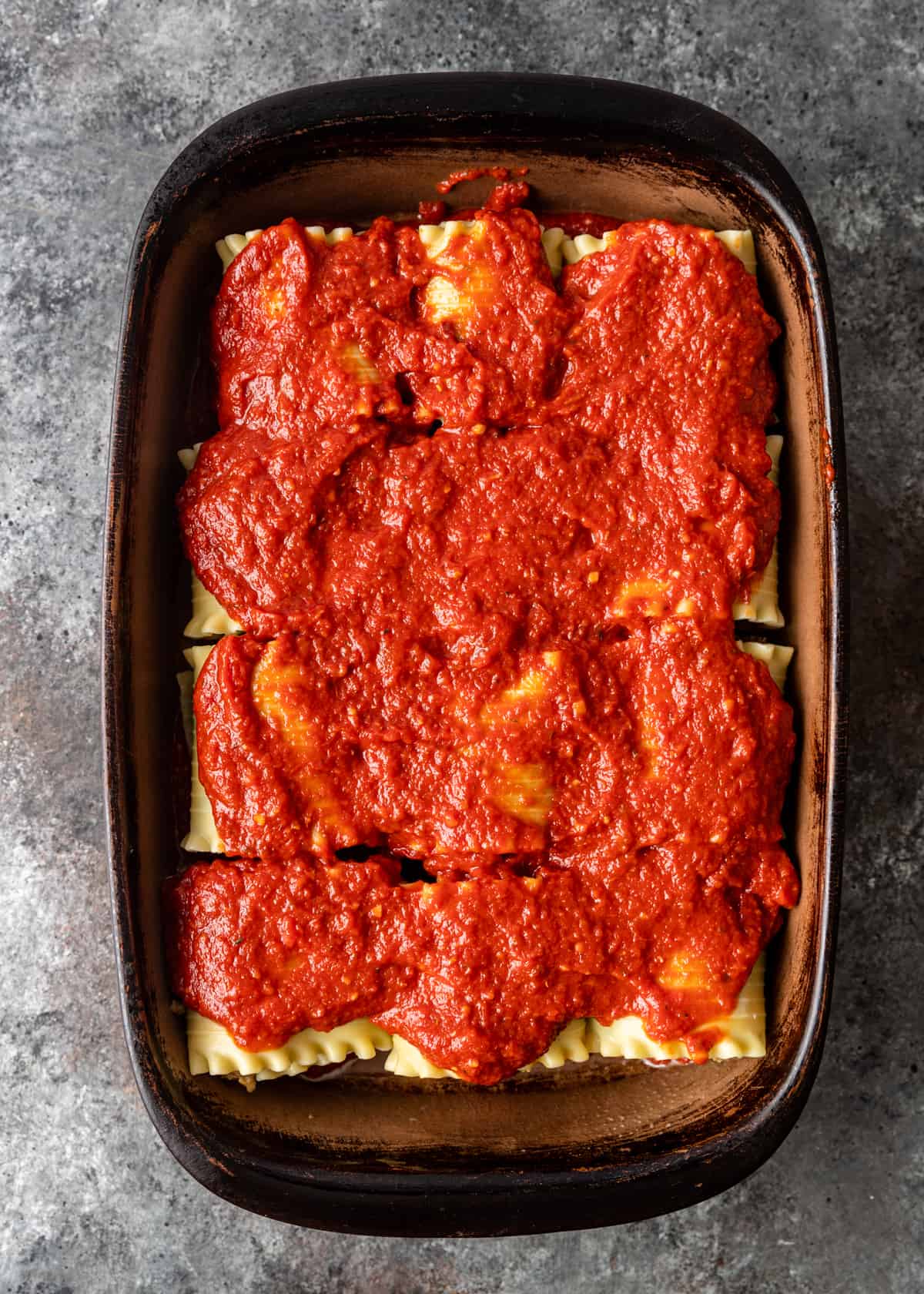 rolled lasagna with red sauce on top