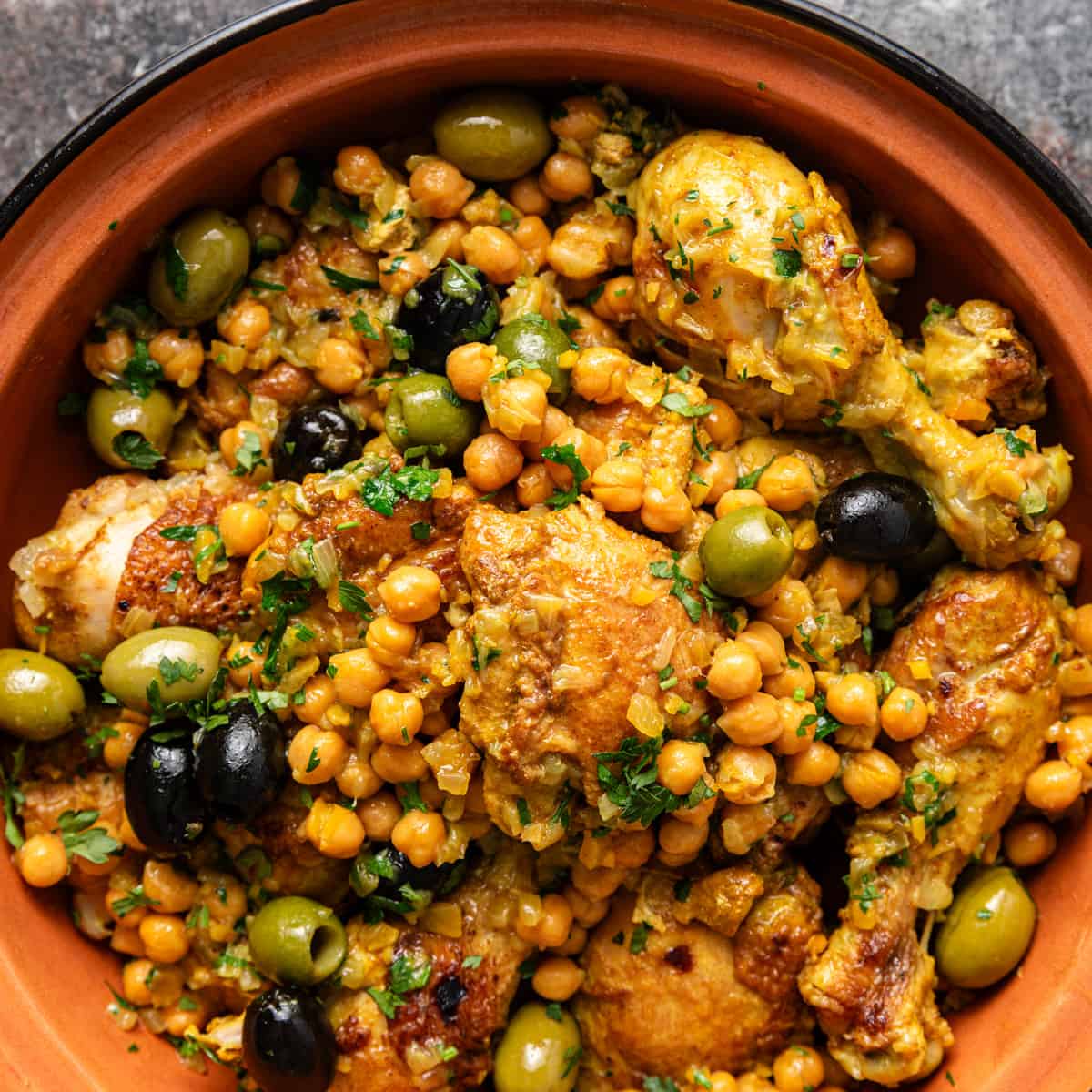overhead closeup: chicken tagine with chickpeas and olives showing