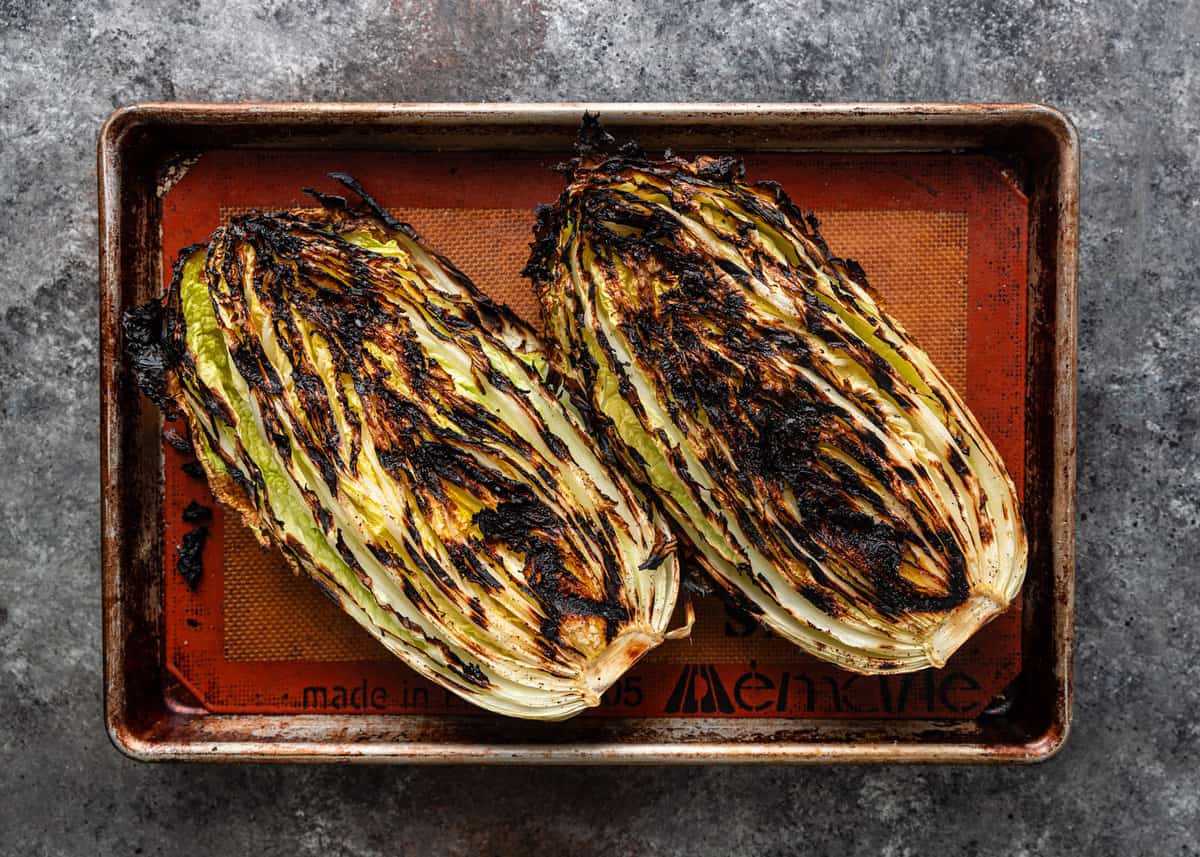 overhead: charred cabbage on a baking sheet