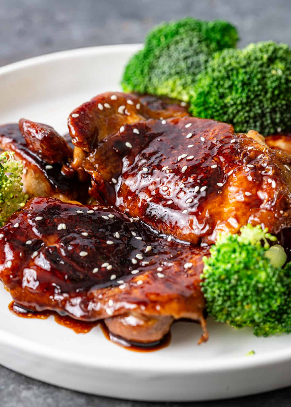 side view: my teriyaki chicken on a white plate with steamed broccoli