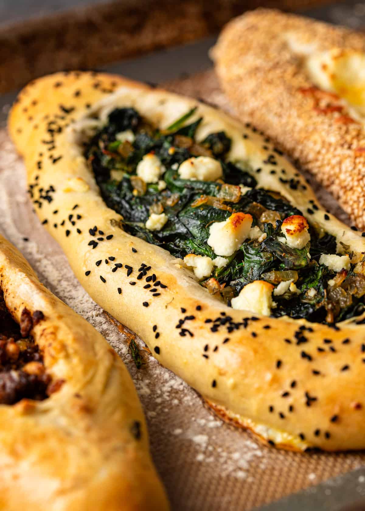 closeup: Turkish pide with spinach and feta filling after baking